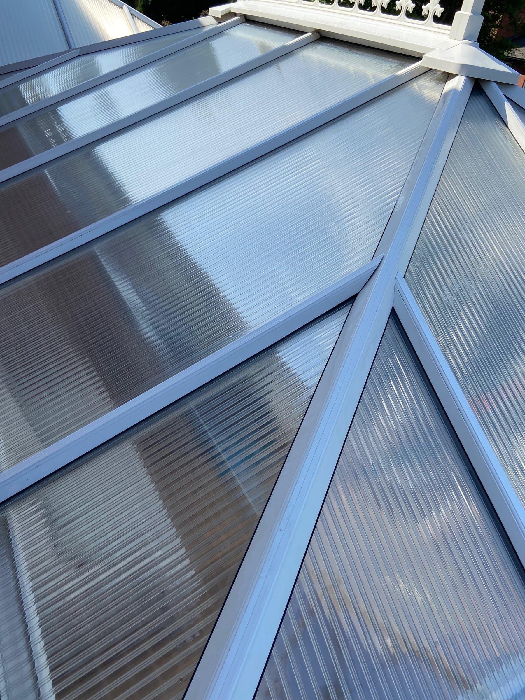 The same conservatory after cleaning — panels clear and the light back through