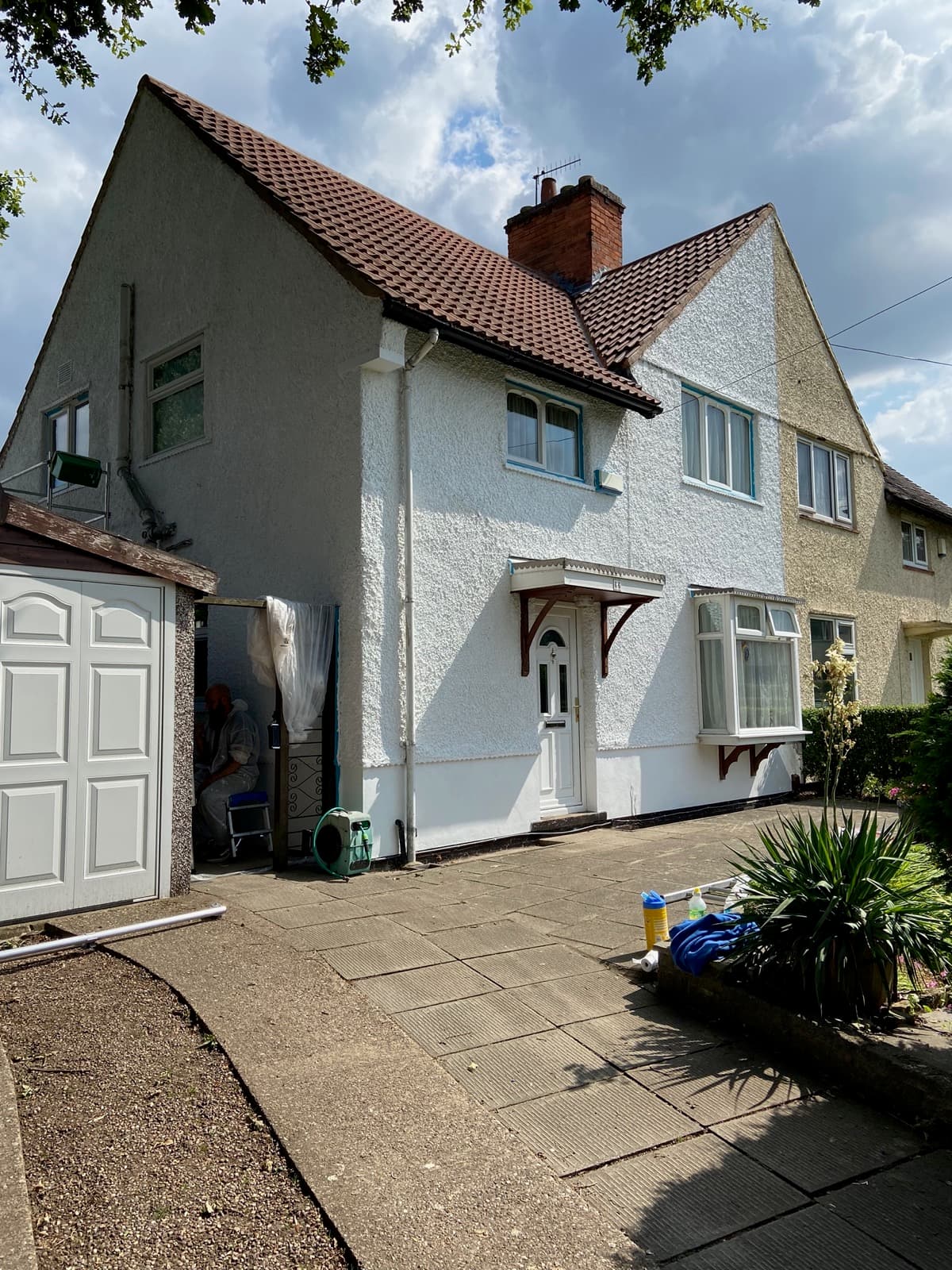 Semi-detached white-render property with brick wall and driveway — full exterior cleaned by Ace Exterior
