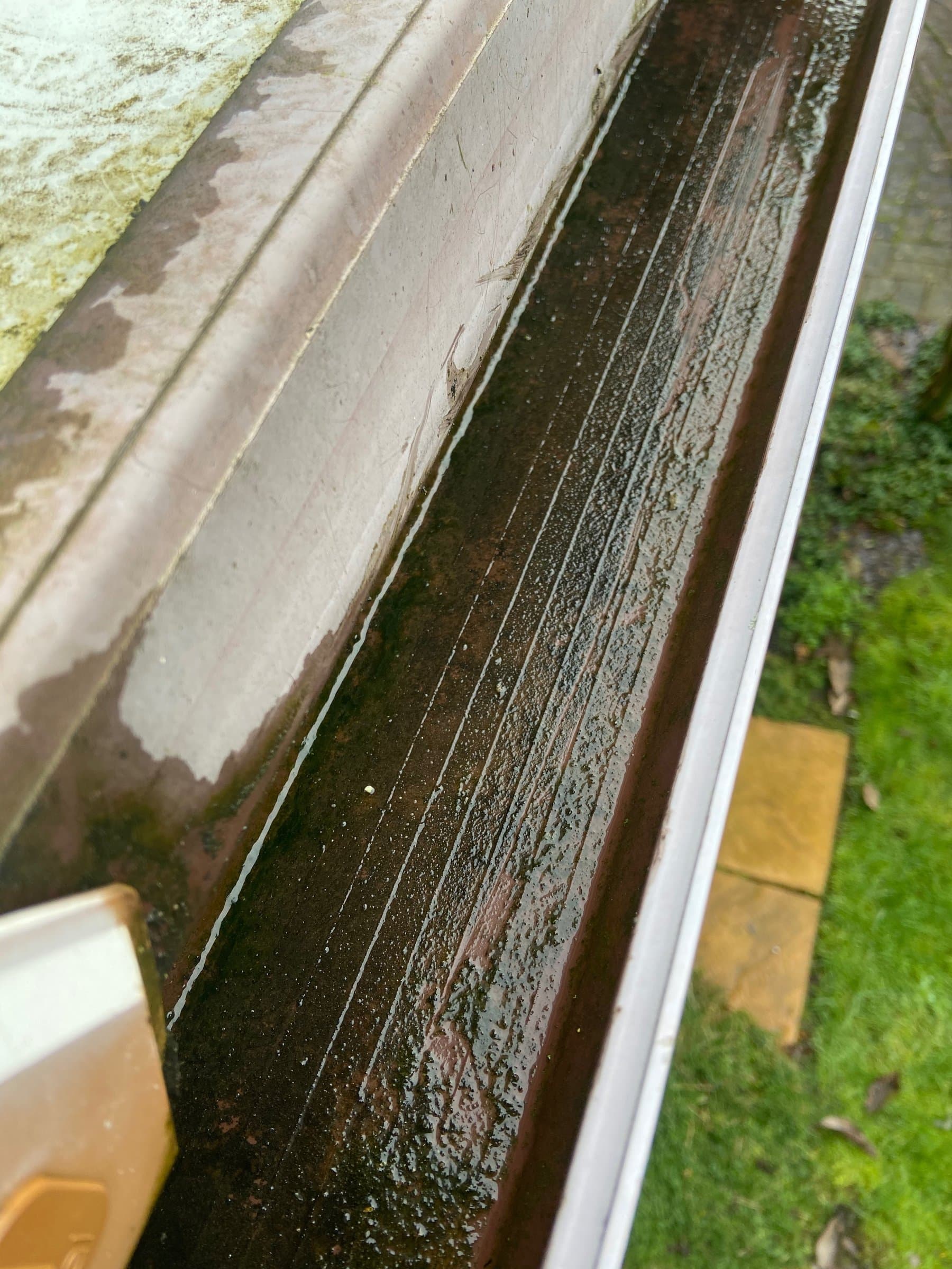 A cleared, free-running gutter — the channel emptied and rinsed