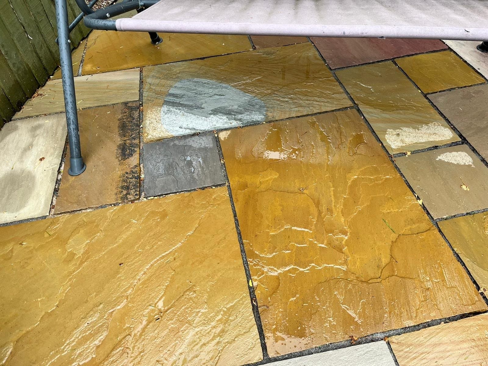 Indian sandstone patio cleaned back to its natural buff-gold colour after treatment and rinse