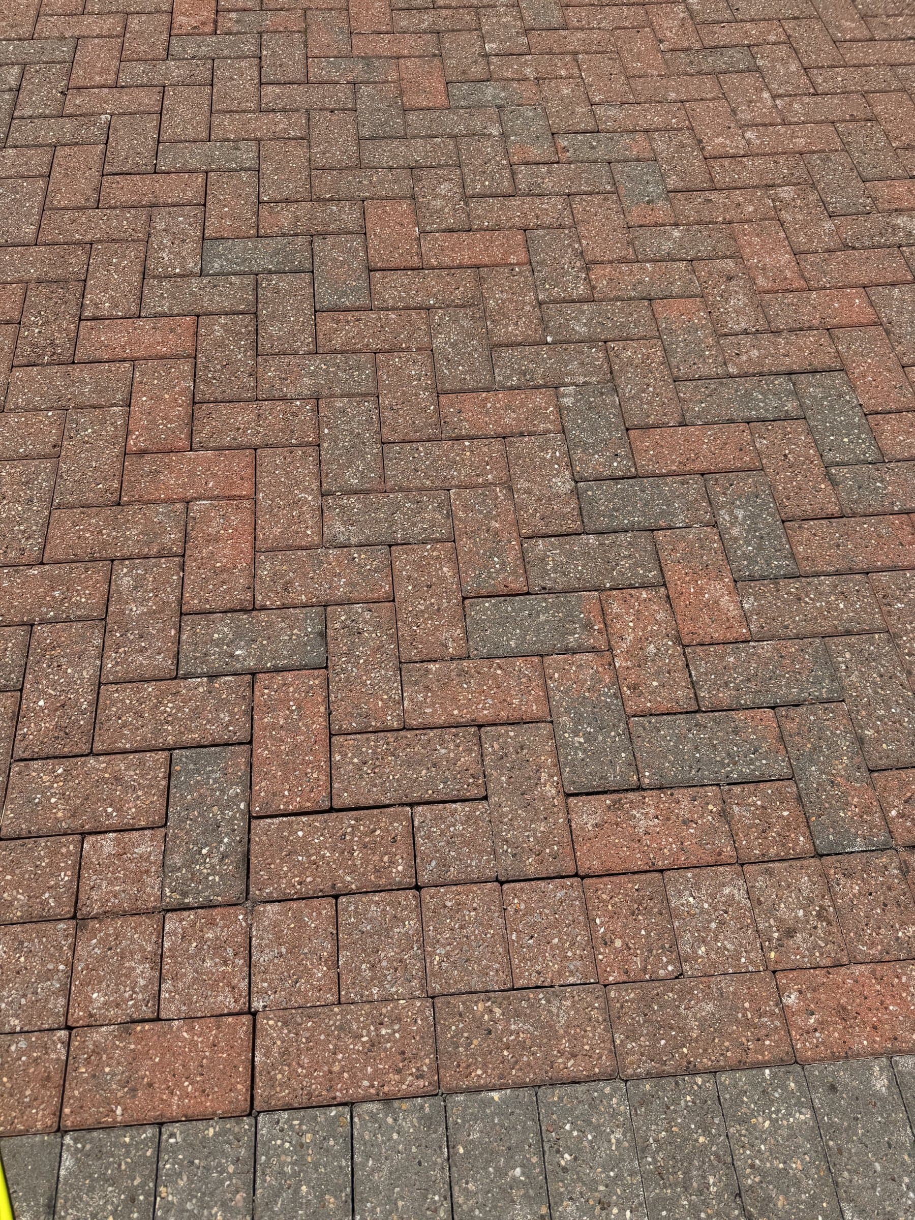 Herringbone block-paved driveway cleaned back to an even, weed-free finish